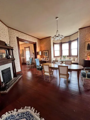 a living room with fireplace furniture and a large window