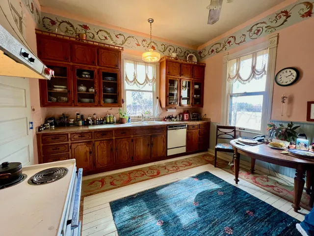 a kitchen with stainless steel appliances wooden cabinets and a stove top oven
