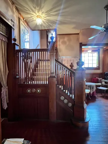 a view of entryway livingroom and hall with wooden floor