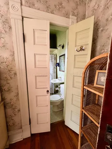 a bathroom with a sink toilet and mirror