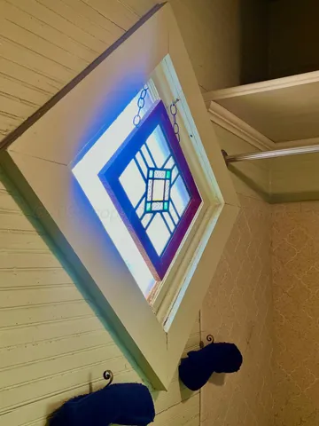 a bedroom with a bed a window and dresser