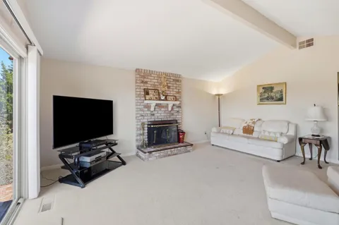 a view of kitchen and living room with wooden floor