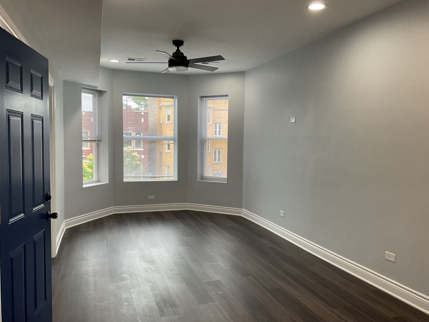 7940 South Carpenter Street, Unit 2 Chicago, IL 60620 - Photo 7 of 34 a view of an empty room with wooden floor and a window