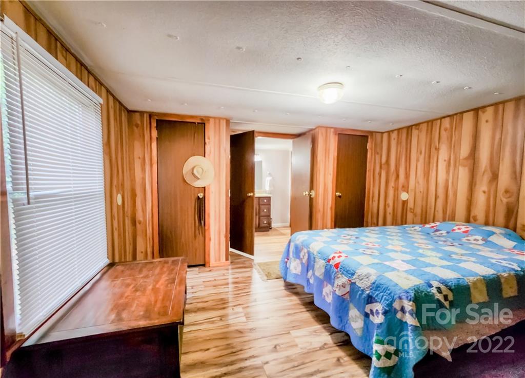 278 Pipers Neck Rutherfordton, NC 28139 - Photo 18 of 42 a bedroom with a bed table and a large mirror