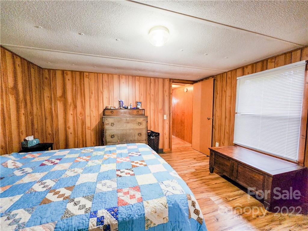 278 Pipers Neck Rutherfordton, NC 28139 - Photo 19 of 42 a bedroom with a bed and a chandelier