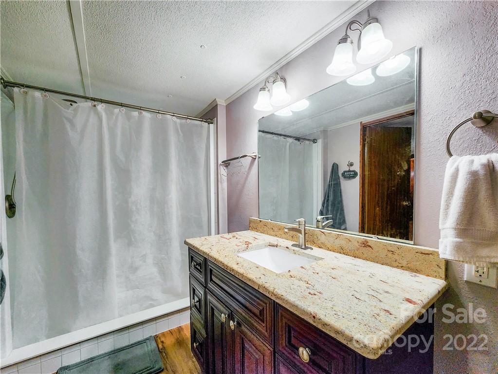 278 Pipers Neck Rutherfordton, NC 28139 - Photo 21 of 42 a bathroom with a granite countertop sink and a mirror