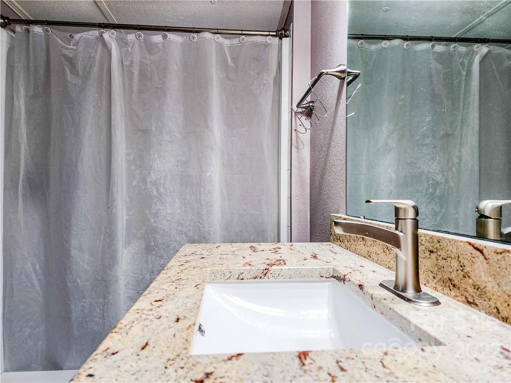 278 Pipers Neck Rutherfordton, NC 28139 - Photo 22 of 42 a bathroom with a granite countertop sink and a mirror
