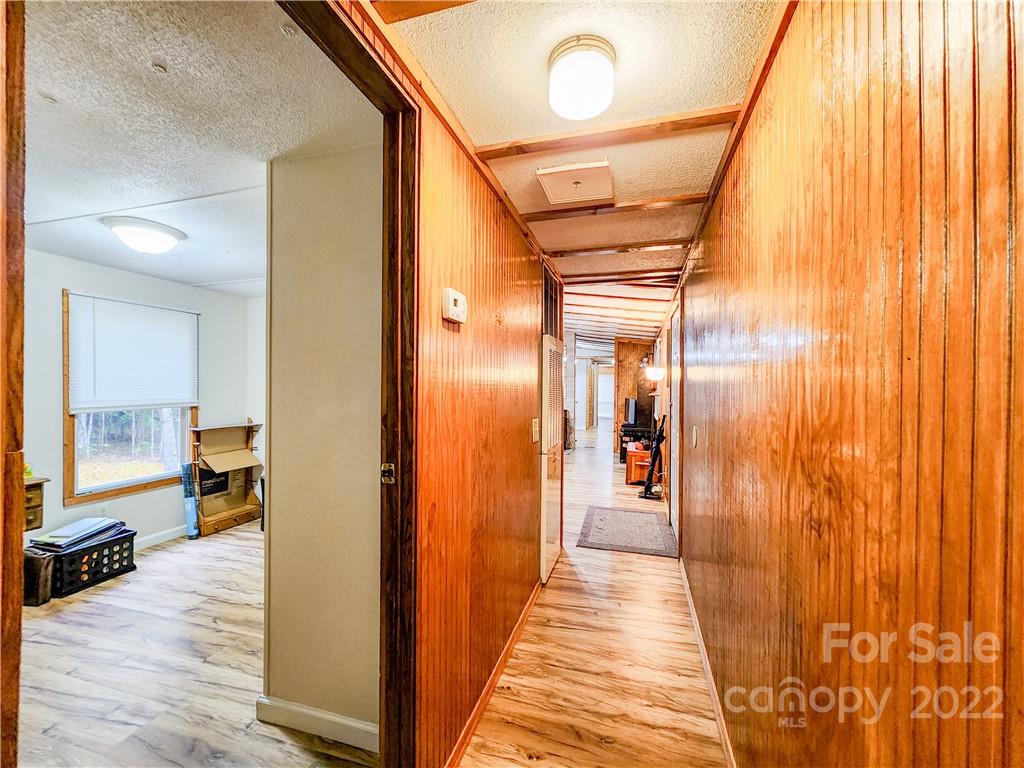 278 Pipers Neck Rutherfordton, NC 28139 - Photo 23 of 42 a view of a hallway with wooden floor and furniture