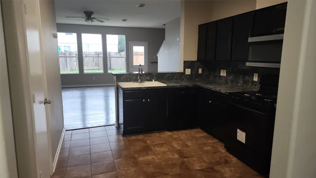 a kitchen with a sink and a refrigerator