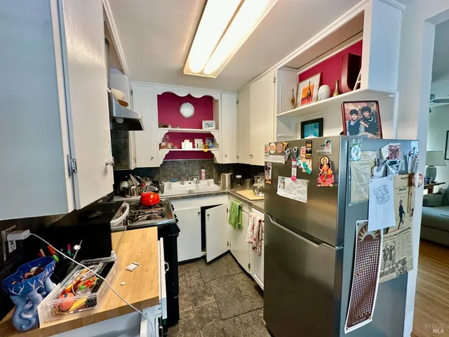 a kitchen with a refrigerator and a stove