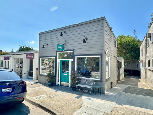 a view of a patio with table and chairs with wooden floor and fence