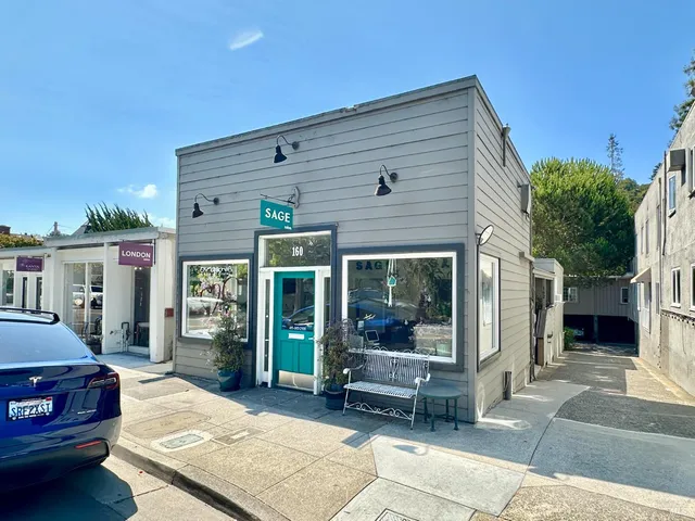 a view of a patio with table and chairs with wooden floor and fence