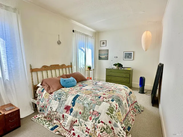 a bedroom with a bed and a dresser in it