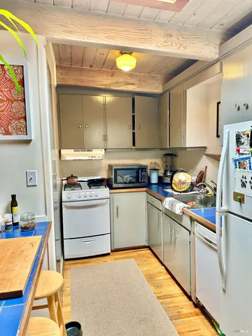 a kitchen with a stove a sink and a cabinets