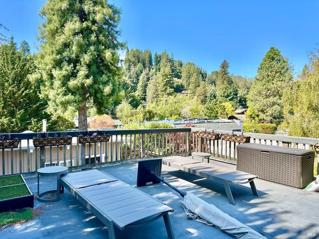 a view of a balcony with wooden floor and outdoor seating