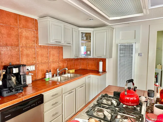 a kitchen with a sink stove and cabinets