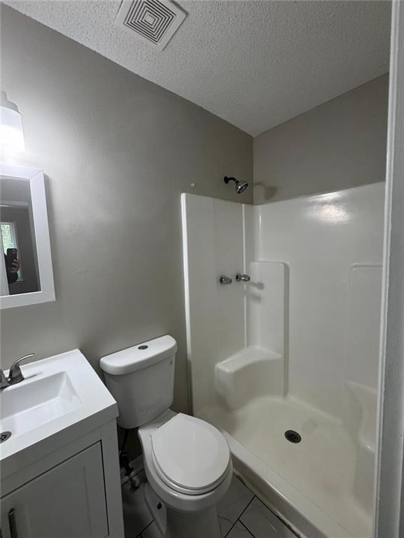 385 Holly Ridge Drive Northwest, Unit 5 Lilburn, GA 30047 - Photo 6 of 10 a white toilet sitting next to a bathroom sink