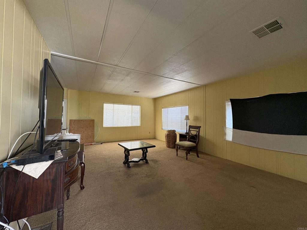 15420 Olde Highway 80 El Cajon, CA 92021 - Photo 26 of 48 a living room with furniture and a flat screen tv