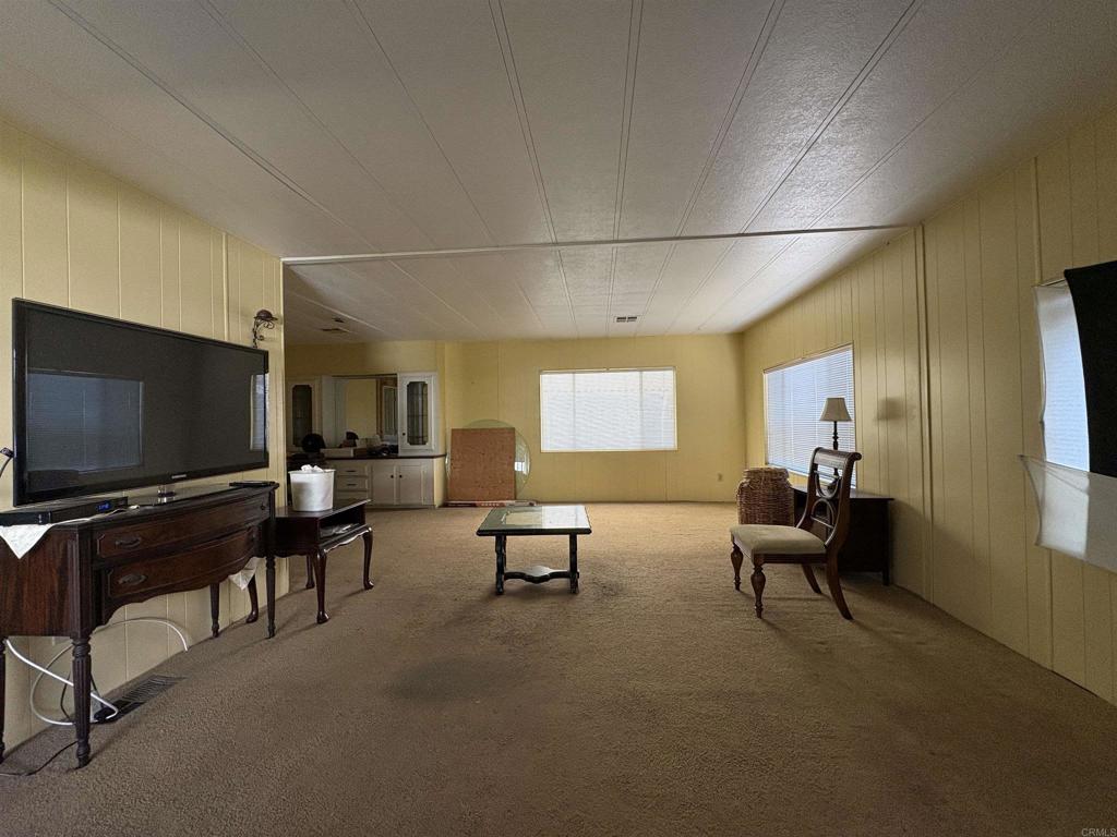 15420 Olde Highway 80 El Cajon, CA 92021 - Photo 27 of 48 a living room with furniture and a flat screen tv
