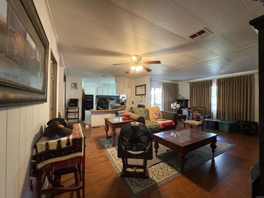 15420 Olde Highway 80 El Cajon, CA 92021 - Photo 33 of 48 a living room with furniture a rug and a window