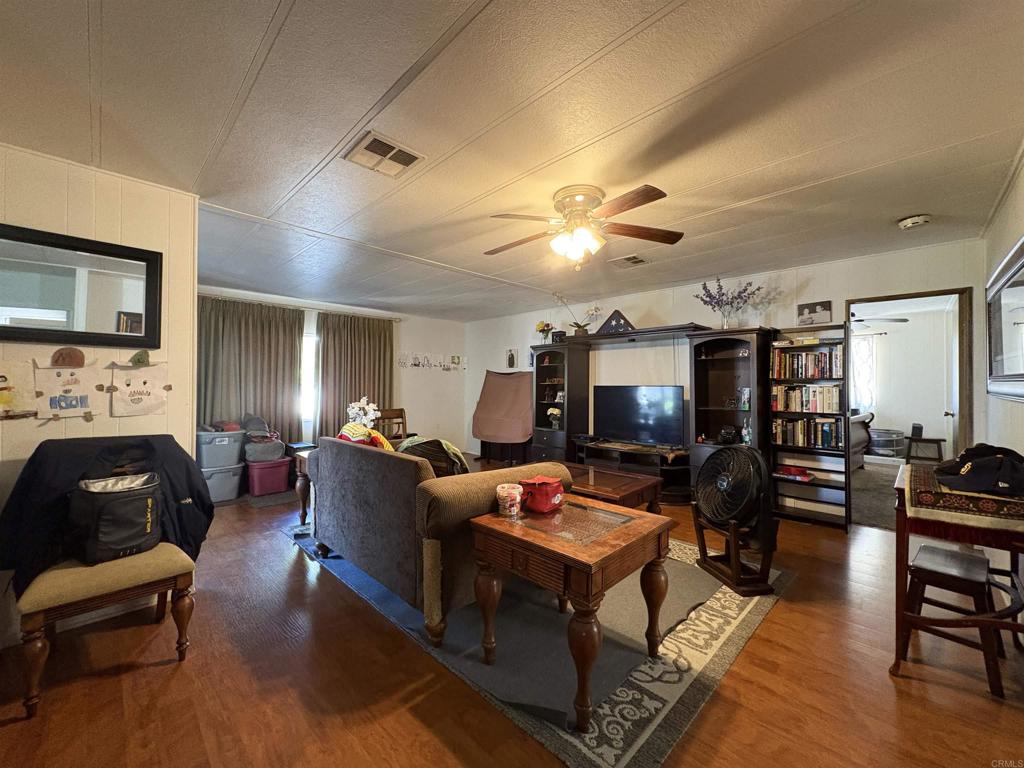 15420 Olde Highway 80 El Cajon, CA 92021 - Photo 34 of 48 a living room with furniture a flat screen tv and a fireplace