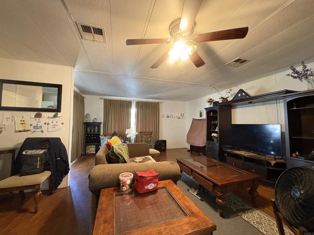 15420 Olde Highway 80 El Cajon, CA 92021 - Photo 35 of 48 a living room with furniture and a flat screen tv