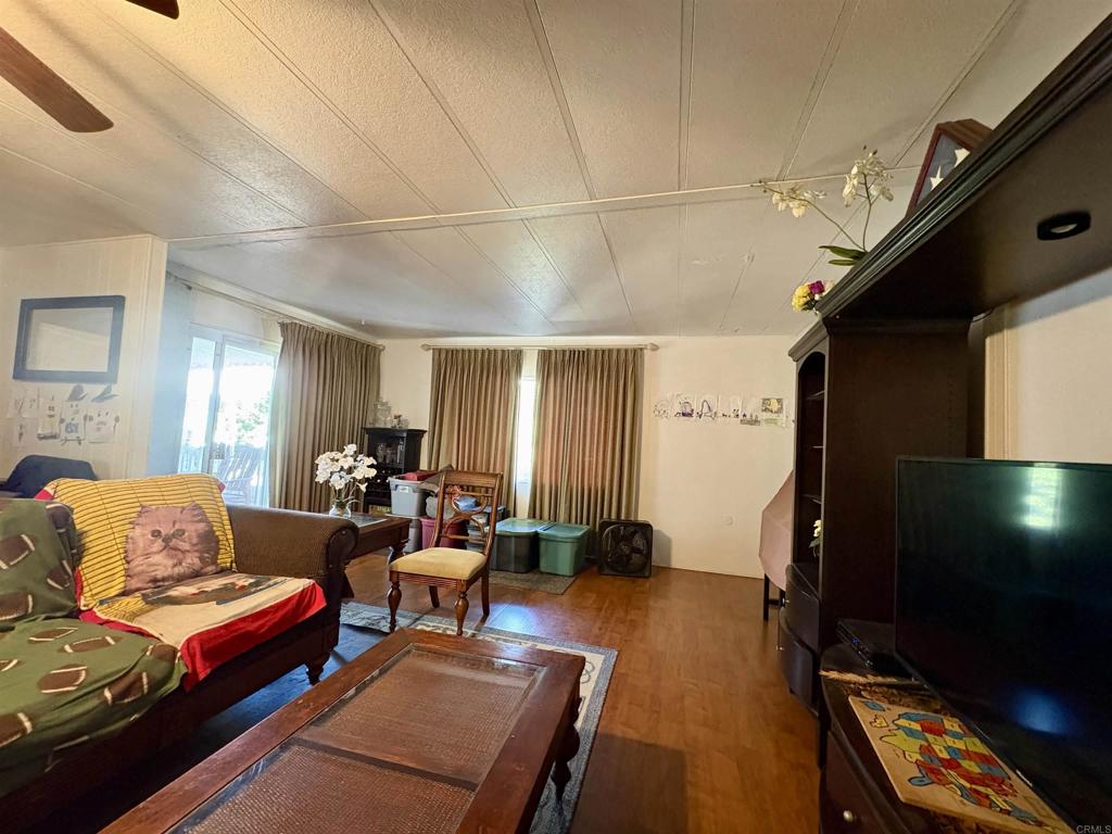 15420 Olde Highway 80 El Cajon, CA 92021 - Photo 36 of 48 a living room with furniture and a flat screen tv