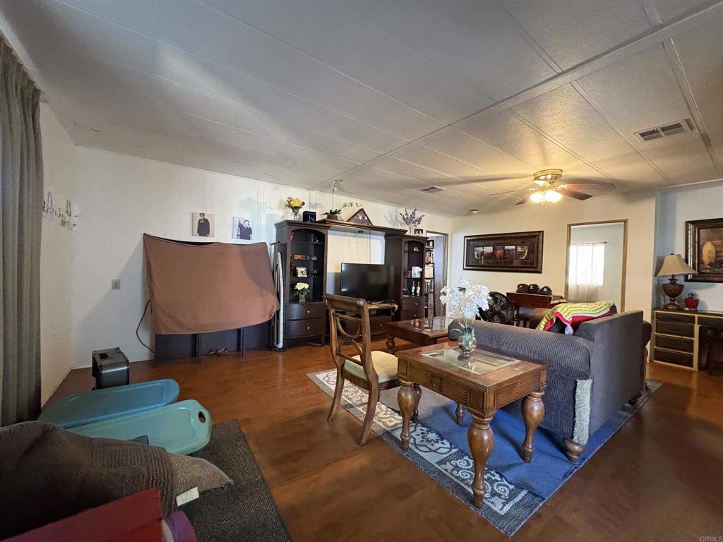 15420 Olde Highway 80 El Cajon, CA 92021 - Photo 37 of 48 a living room with furniture and a flat screen tv