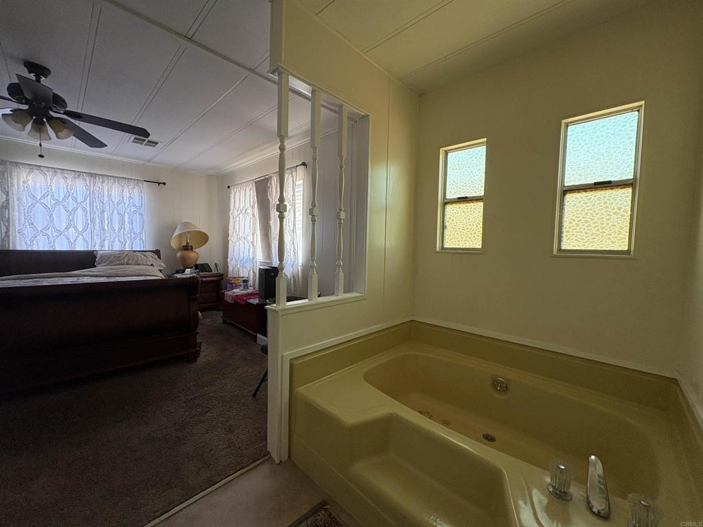 15420 Olde Highway 80 El Cajon, CA 92021 - Photo 42 of 48 a bath room with a bathtub and a window