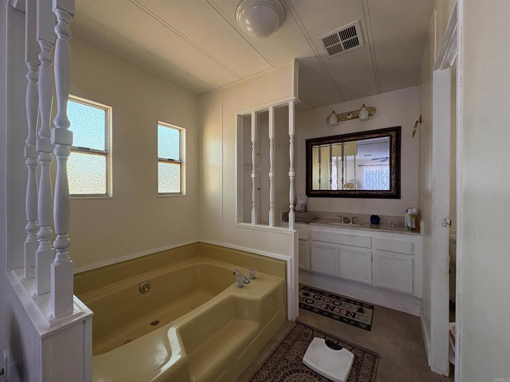 15420 Olde Highway 80 El Cajon, CA 92021 - Photo 43 of 48 a bathroom with a tub sink and mirror
