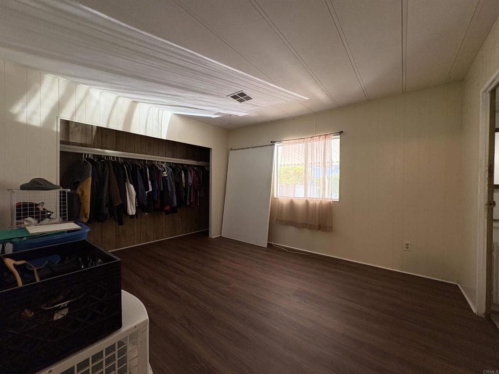 15420 Olde Highway 80 El Cajon, CA 92021 - Photo 46 of 48 a view of an empty room with wooden floor fireplace and a window
