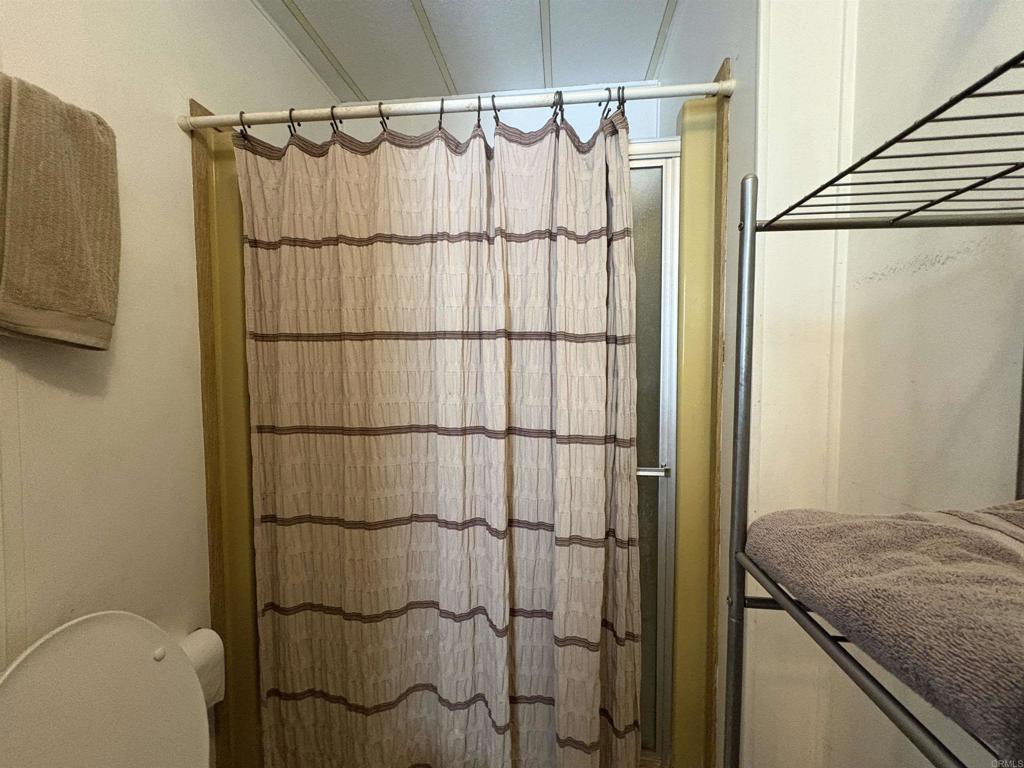 15420 Olde Highway 80 El Cajon, CA 92021 - Photo 48 of 48 a bathroom with a granite countertop shower a mirror and a sink