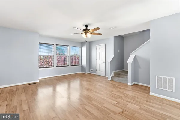 wooden floor in an empty room with a window