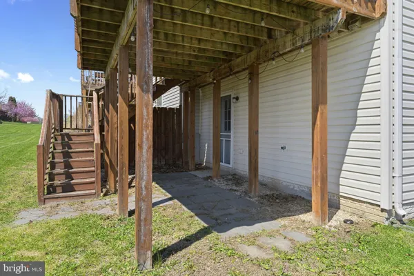 a view of a house with backyard and wooden fence