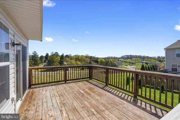 a view of balcony with wooden floor and fence