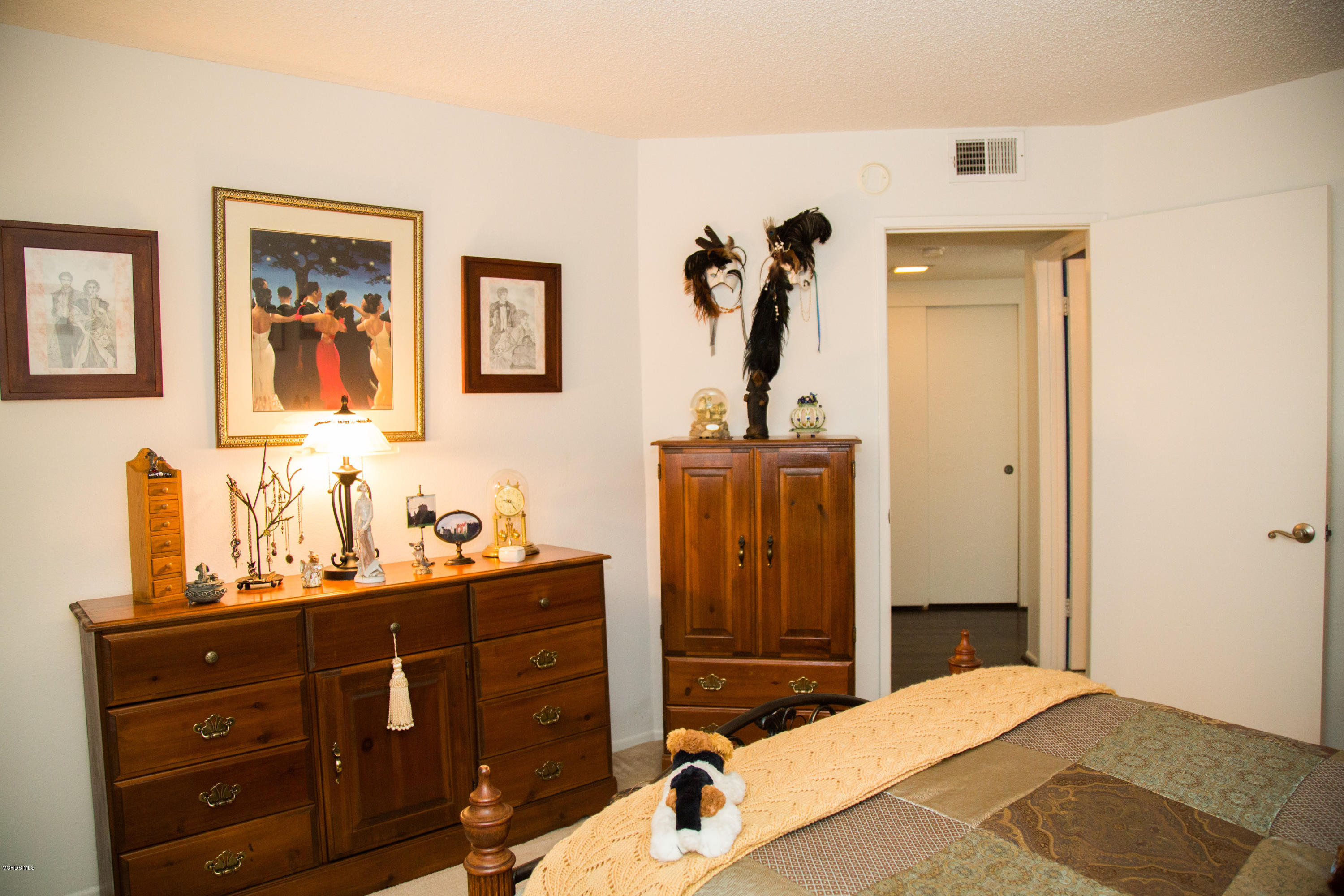 1724 Sinaloa Road, Unit 126 Simi Valley, CA 93065 - Photo 22 of 26 a bedroom with a bed and a dresser