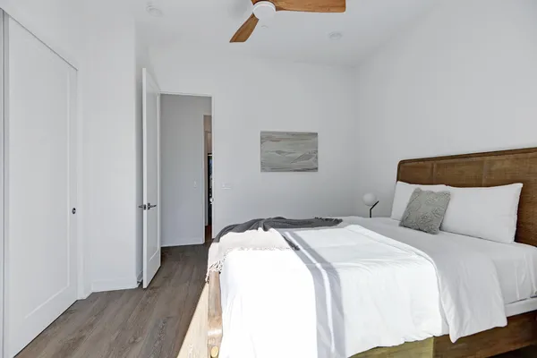 a bedroom with a bed and wooden floor