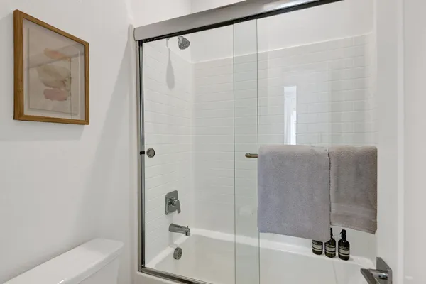 a bathroom with a bathtub and a shower