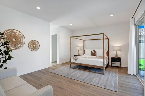 a bedroom with a bed and a chandelier