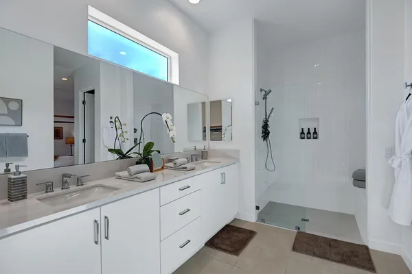 a bathroom with a double vanity sink and mirror