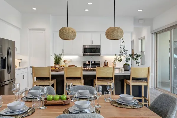 a kitchen with stainless steel appliances granite countertop a stove and a wooden floor