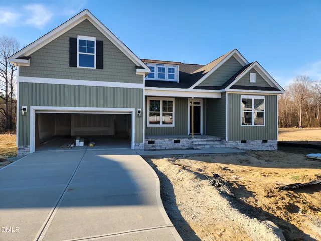 a view of a house with a yard and sitting area