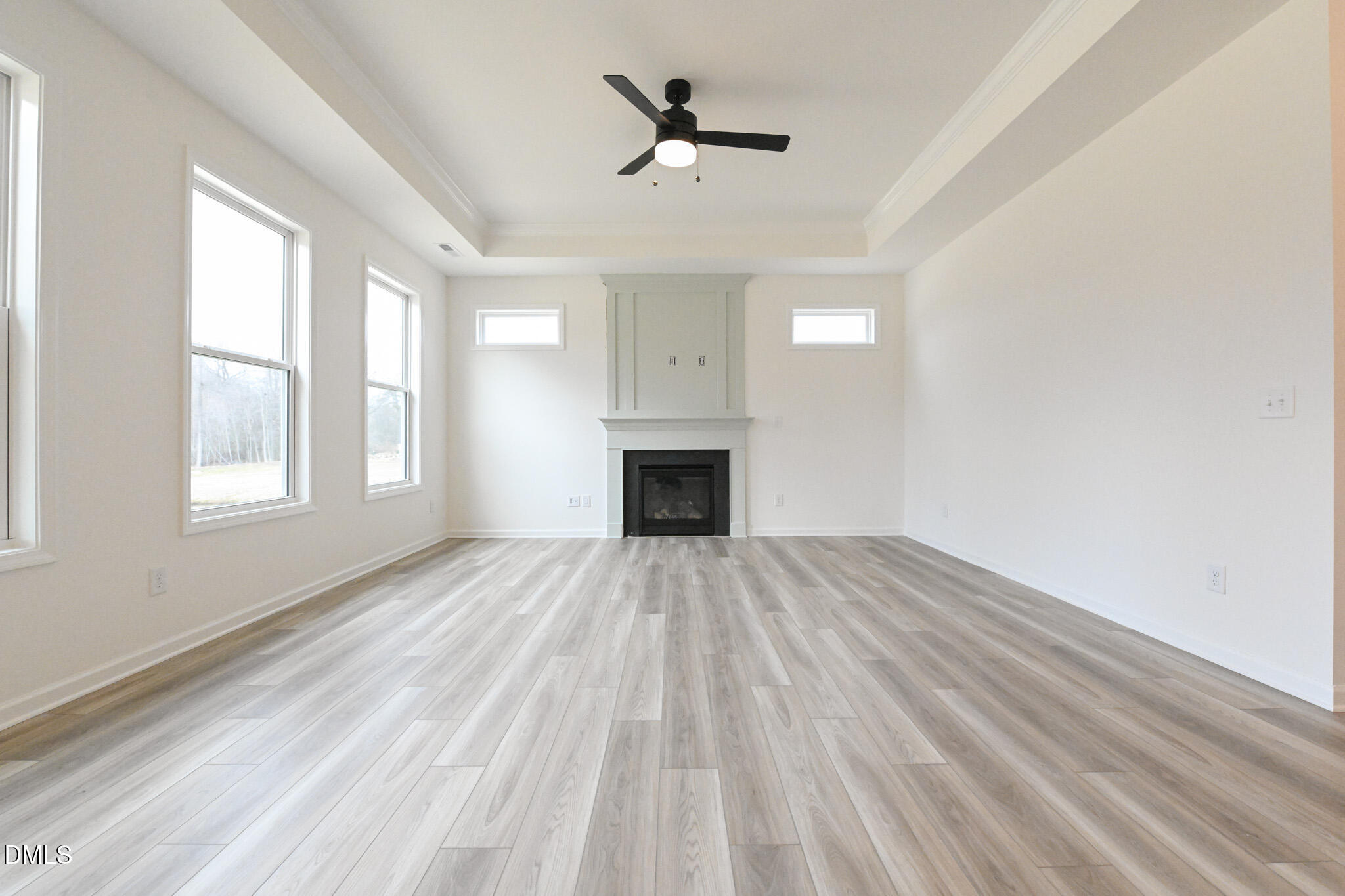 72 South Bream Court Angier, NC 27501 - Photo 11 of 44 an empty room with wooden floor ceiling fan and windows