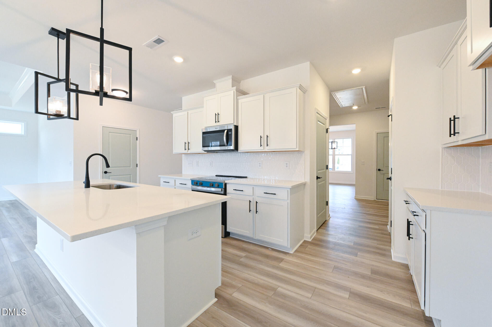 72 South Bream Court Angier, NC 27501 - Photo 17 of 44 a kitchen with white cabinets appliances and a sink