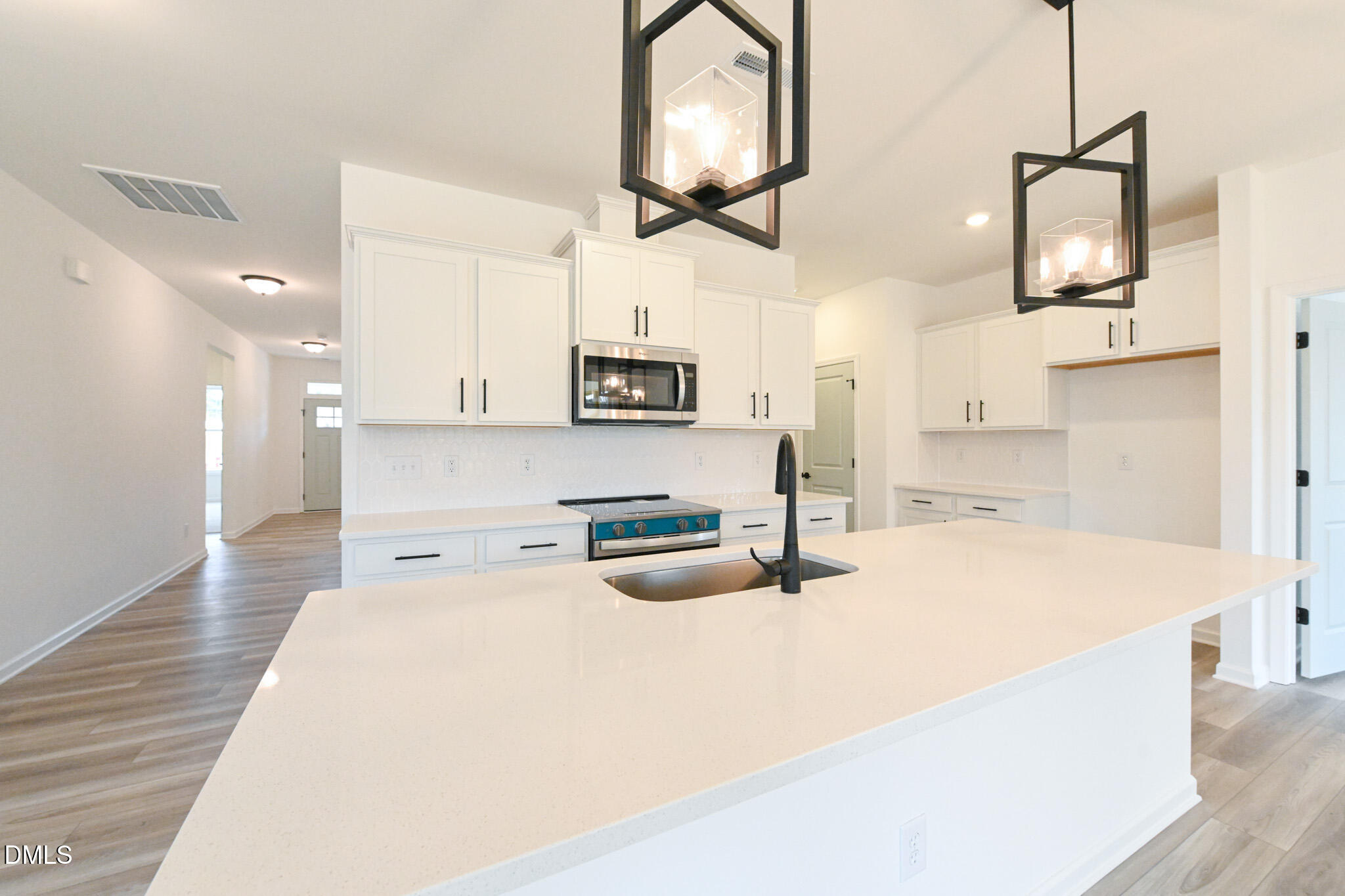 72 South Bream Court Angier, NC 27501 - Photo 18 of 44 a kitchen with stainless steel appliances granite countertop a sink a stove top oven a counter space and cabinets