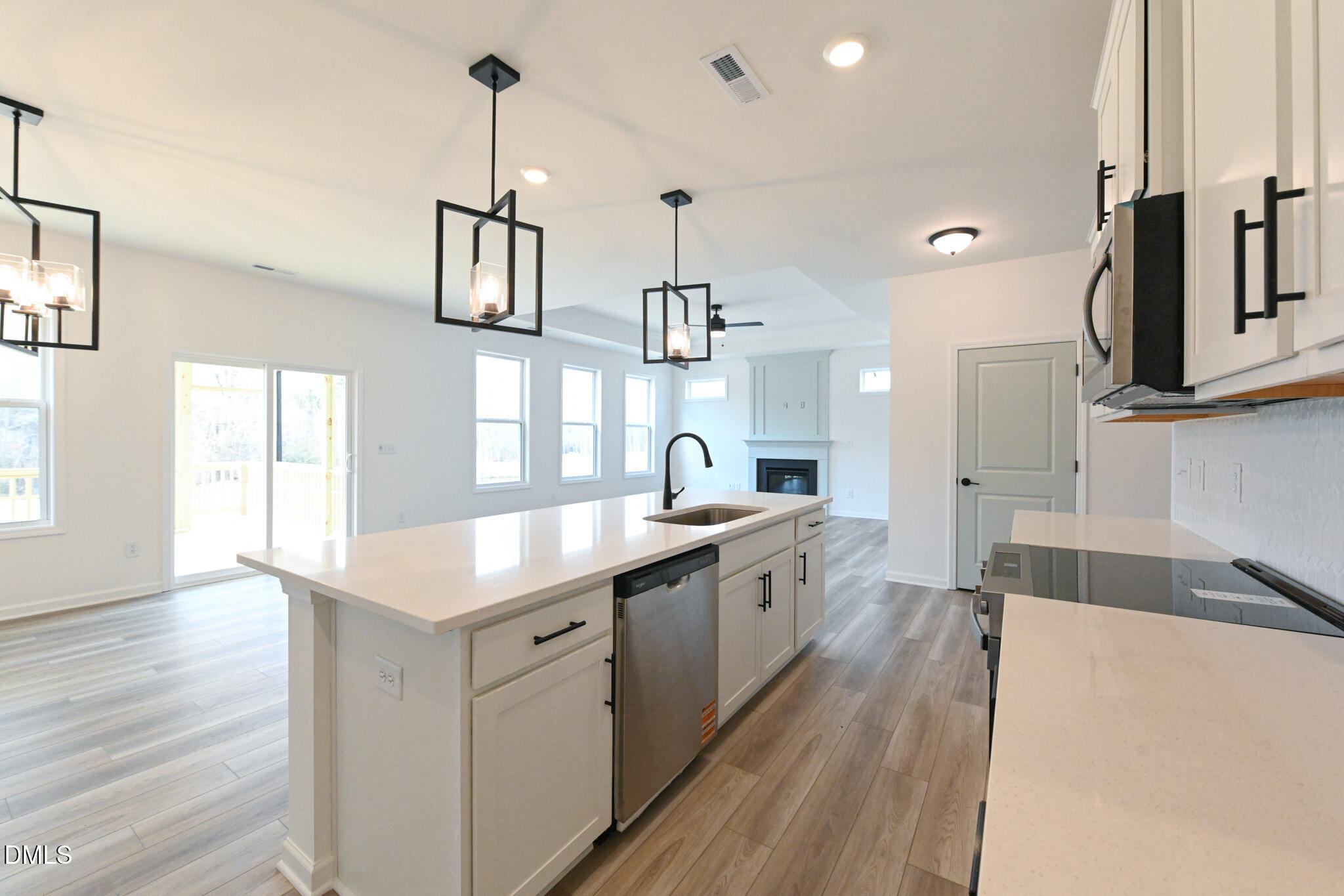 72 South Bream Court Angier, NC 27501 - Photo 20 of 44 a large kitchen with granite countertop a sink dishwasher a stove and a wooden floor