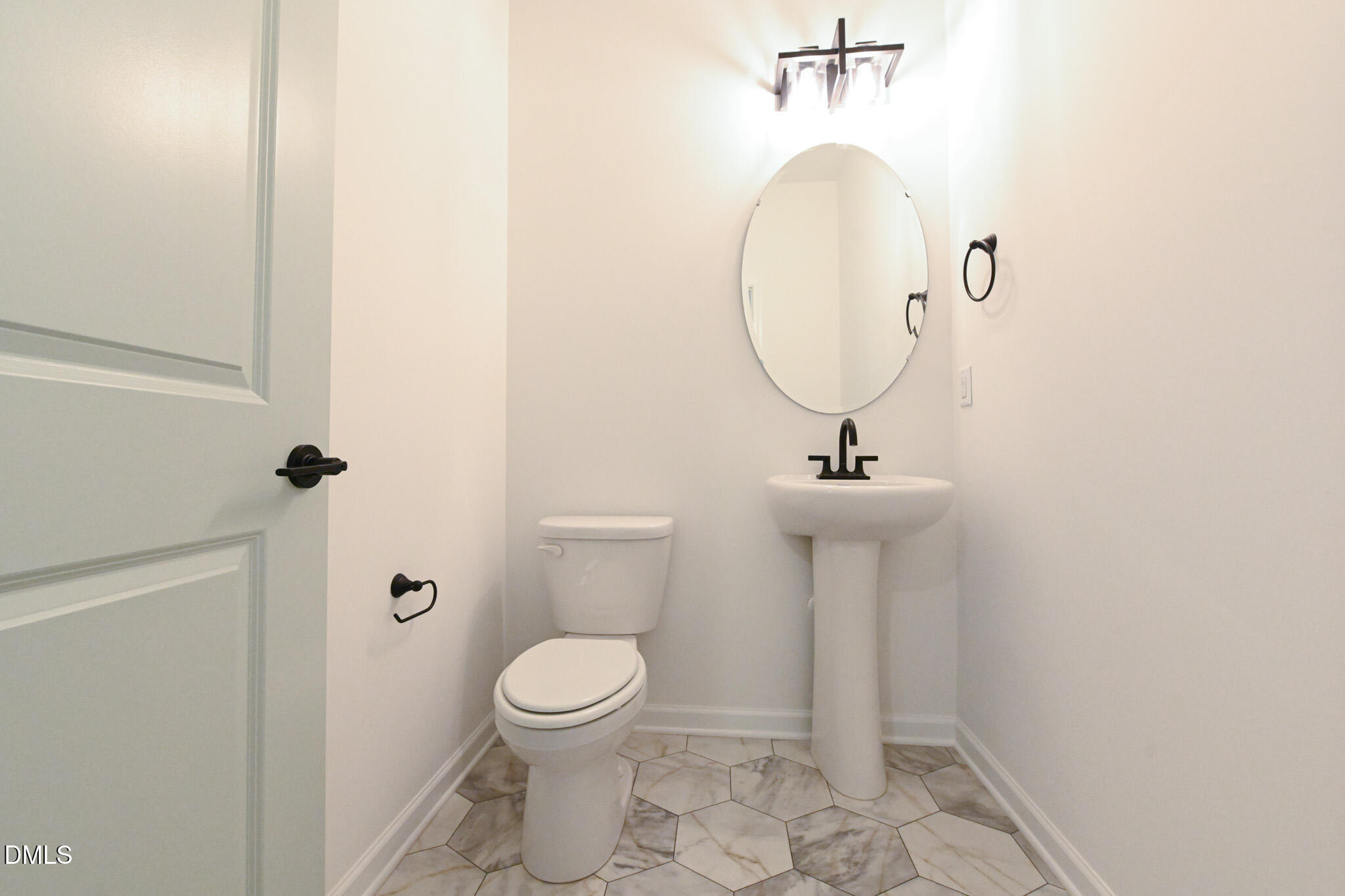 72 South Bream Court Angier, NC 27501 - Photo 23 of 44 a bathroom with a toilet sink and mirror
