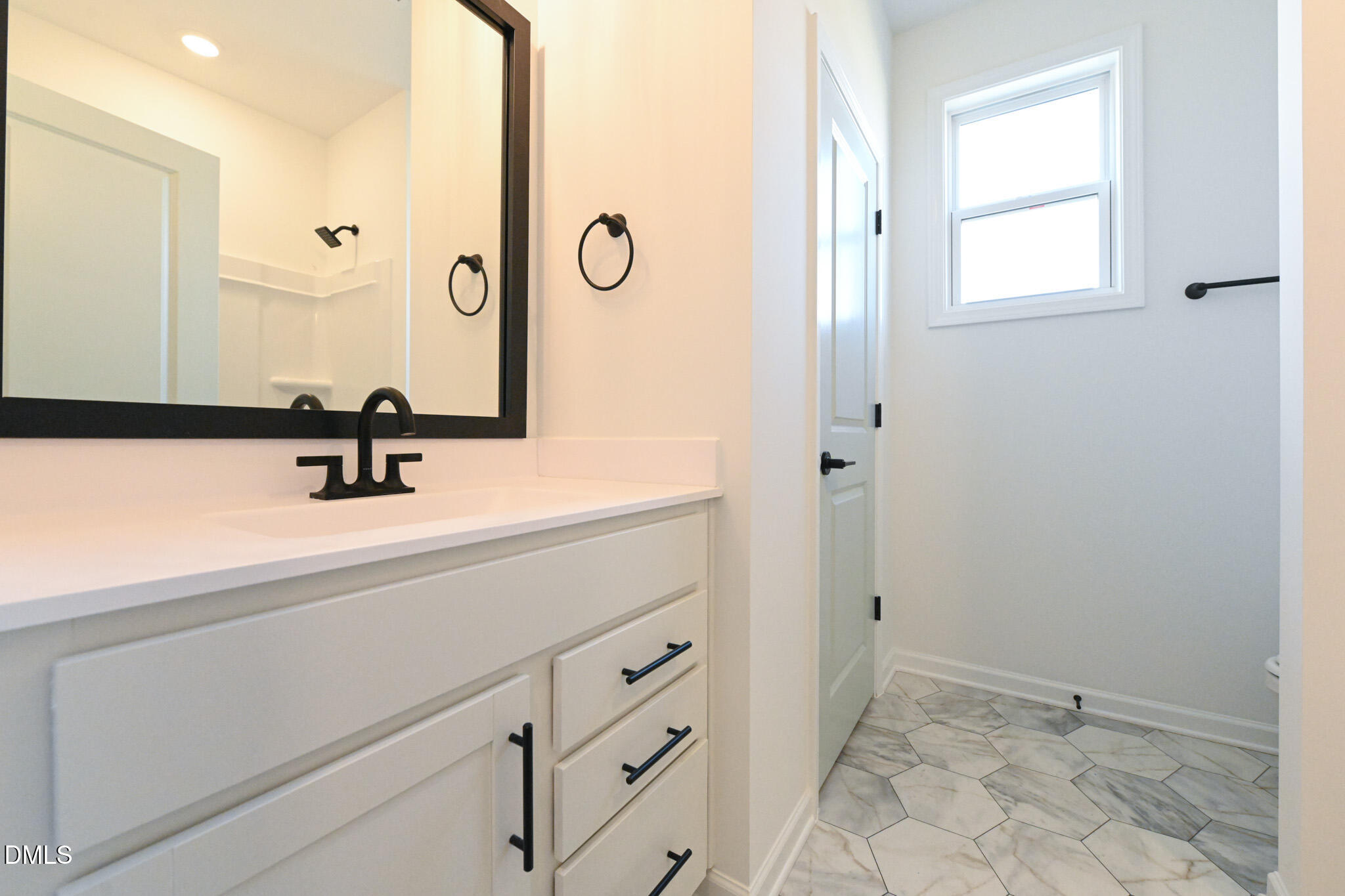 72 South Bream Court Angier, NC 27501 - Photo 33 of 44 a bathroom with a sink a mirror and shower