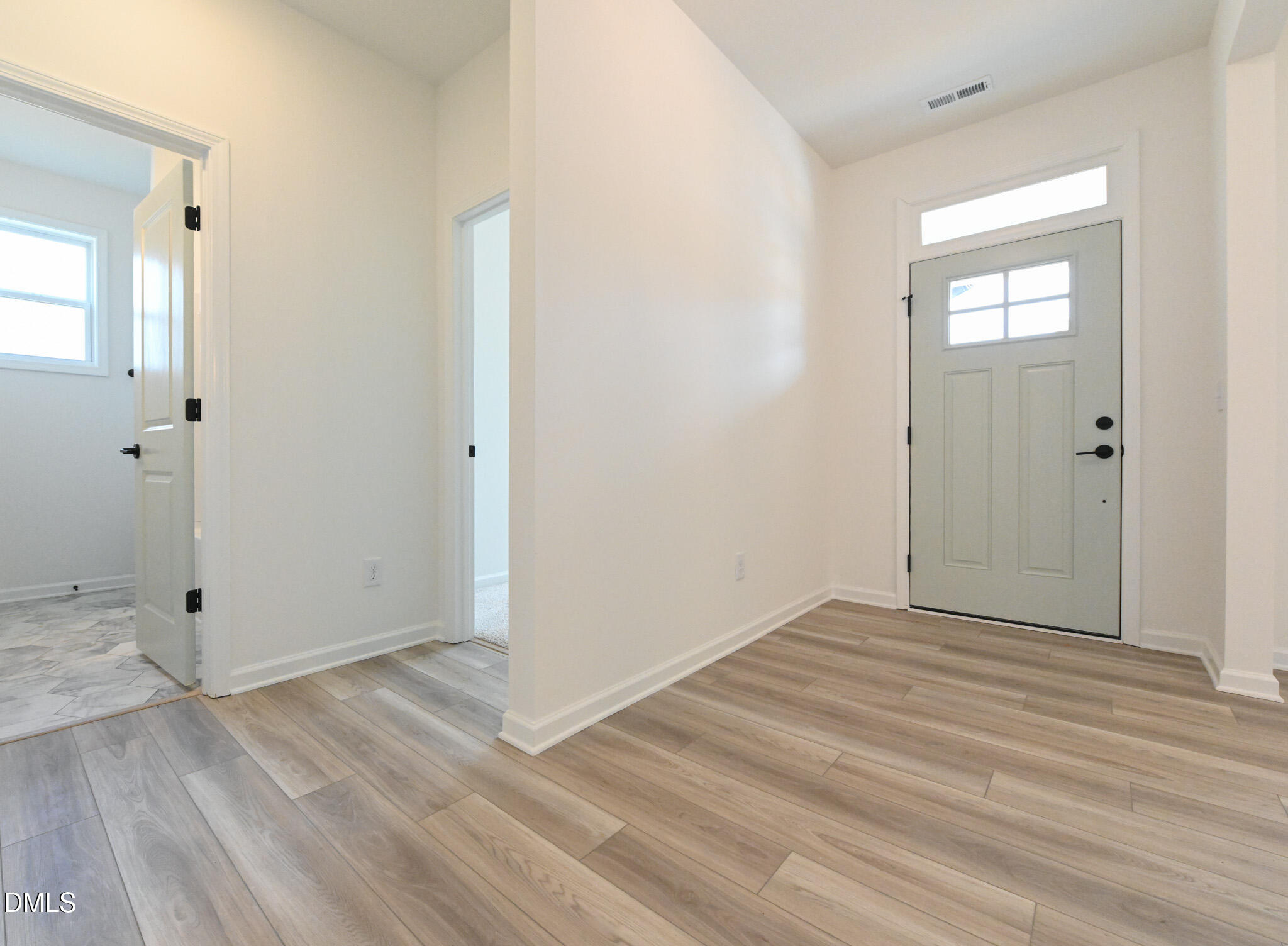 72 South Bream Court Angier, NC 27501 - Photo 5 of 44 an empty room with wooden floor and mirror