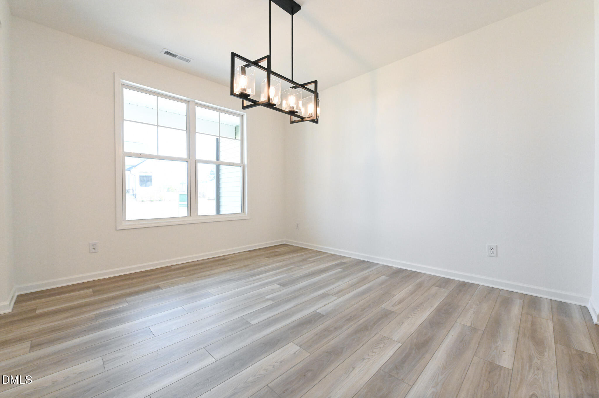 72 South Bream Court Angier, NC 27501 - Photo 7 of 44 a view of empty room with wooden floor and ceiling fan